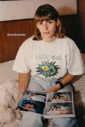 Val�ria Zoppello com uma camiseta dos Mamonas Assassinas e um �lbum de fotografias. Imagem marcada por @amoalecsander.